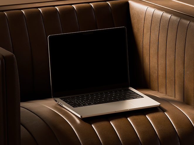 Laptop on brown leather couch representing digital products